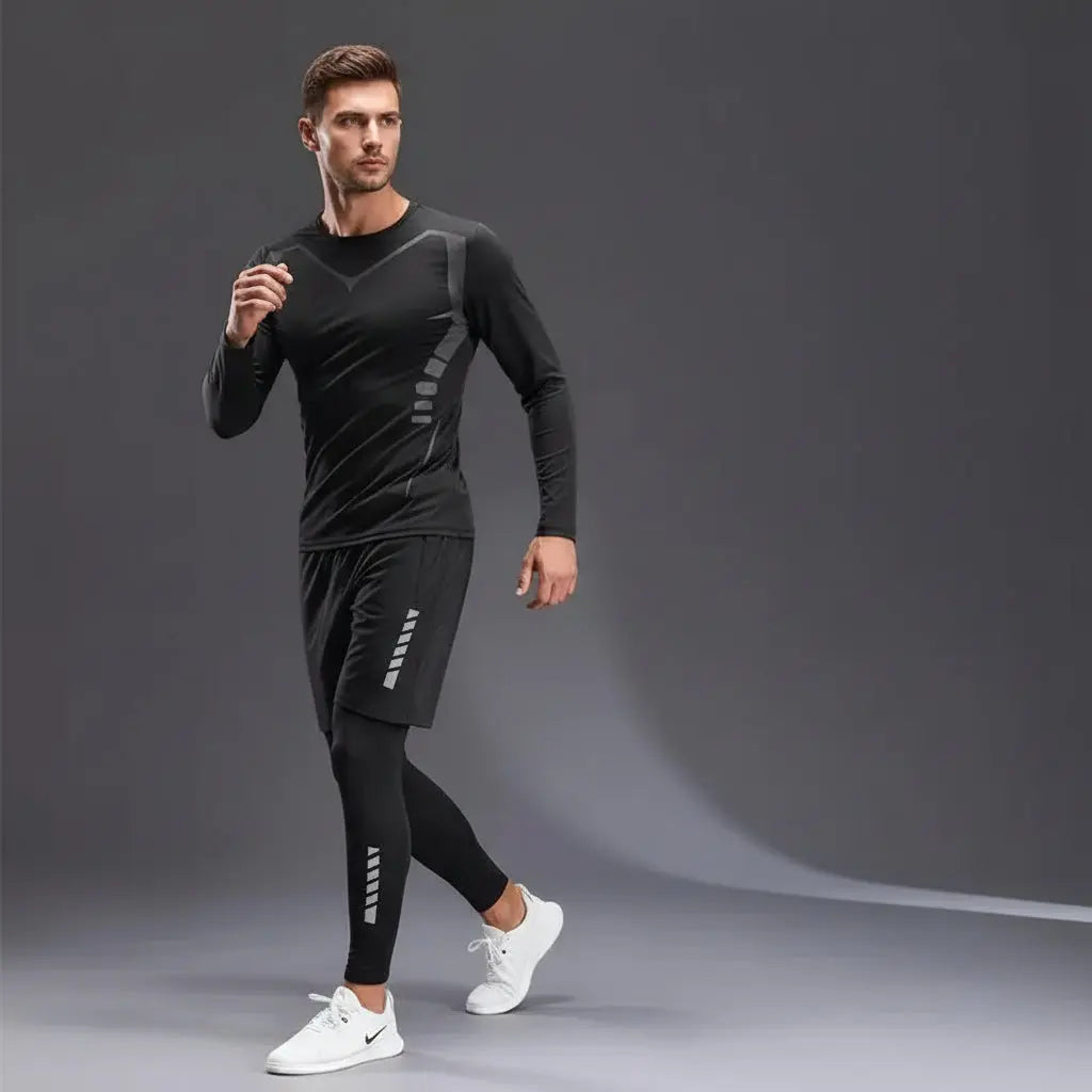 Gray sports three-piece set with long-sleeve top, shorts, and leggings on a gray background.